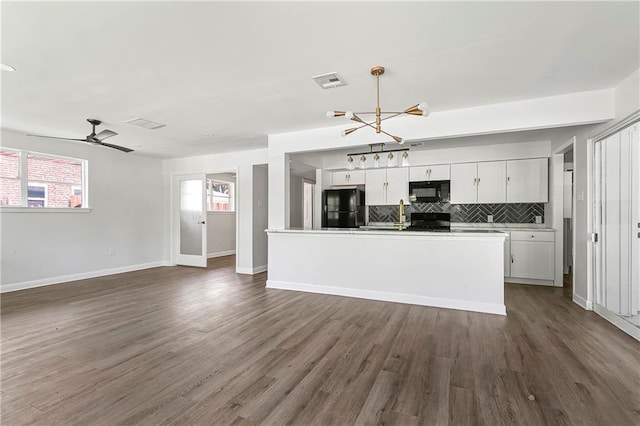 513 Roseland Pkwy, Harahan, LA 70123 - kitchen featuring black appliances, a chandelier, backsplash, white cabinets, and dark wood finished floors