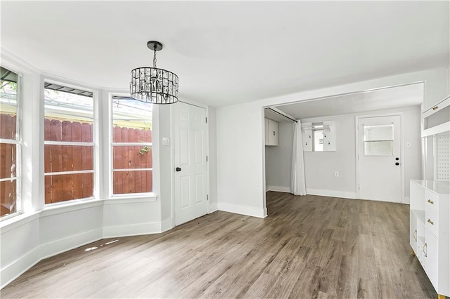 513 Roseland Pkwy, Harahan, LA 70123 - unfurnished dining area with wood finished floors and a chandelier