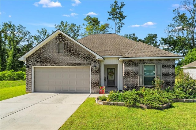 16168 S Trace Ext, Ponchatoula, LA 70454 - view of front of home with brick siding, a garage, concrete driveway, and a front lawn