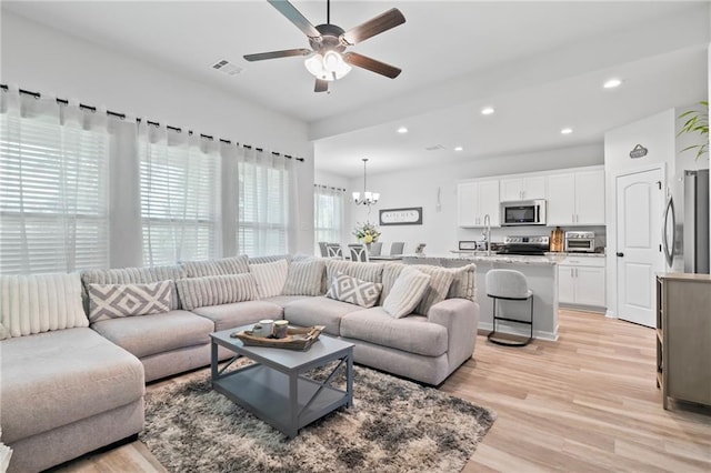 16168 S Trace Ext, Ponchatoula, LA 70454 - living room with ceiling fan, light wood-style floors, a chandelier, and recessed lighting