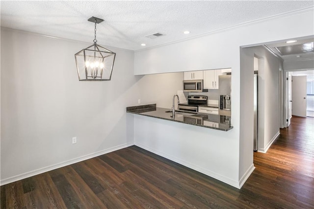 640 Tete Lours Dr Unit 1, Mandeville, LA 70471 - kitchen with stainless steel appliances, dark wood-style floors, white cabinets, crown molding, and recessed lighting