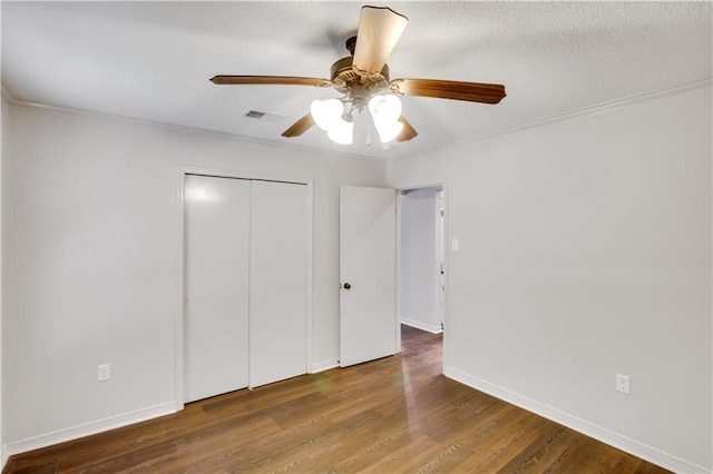 640 Tete Lours Dr Unit 1, Mandeville, LA 70471 - unfurnished bedroom with wood finished floors, a closet, a ceiling fan, and crown molding