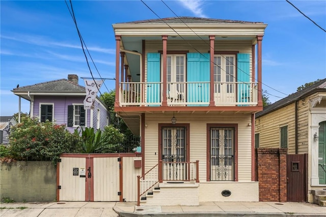827 Port St, New Orleans, LA 70117 - view of front of property with a balcony, a porch, and french doors