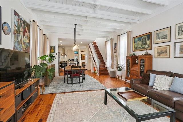 827 Port St, New Orleans, LA 70117 - living area with stairway, hardwood / wood-style floors, and beam ceiling