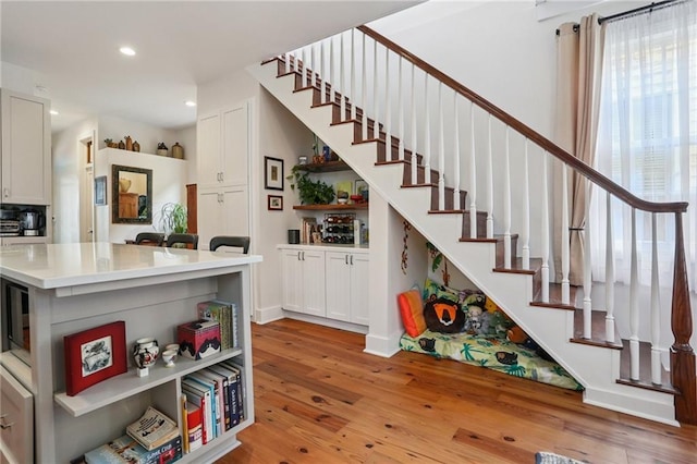 827 Port St, New Orleans, LA 70117 - stairway with wood finished floors and recessed lighting