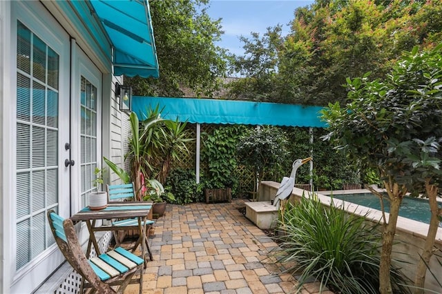 827 Port St, New Orleans, LA 70117 - view of patio / terrace featuring french doors