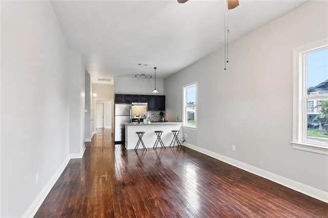 4528-30 Baudin St, New Orleans, LA 70119 - living room with dark wood finished floors, healthy amount of natural light, and ceiling fan