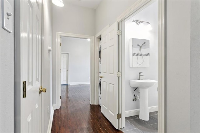 4528-30 Baudin St, New Orleans, LA 70119 - hallway featuring stacked washer and clothes dryer and dark wood-style flooring