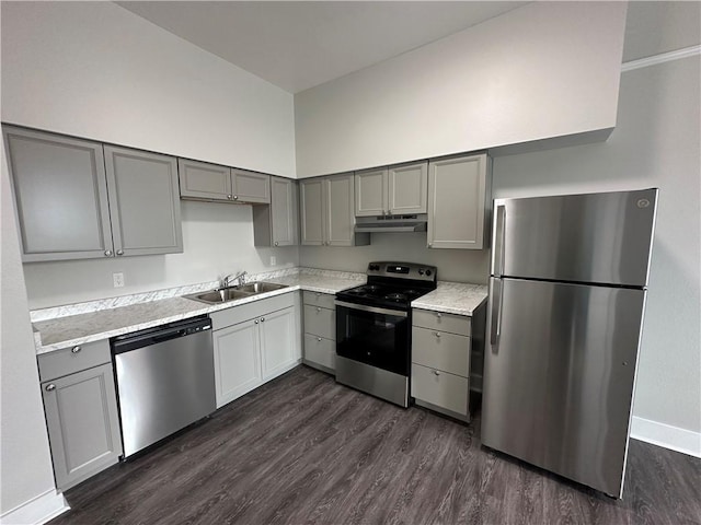 1824 Oretha Castle Haley Blvd Unit 209, New Orleans, LA 70113 - kitchen featuring stainless steel appliances, gray cabinets, under cabinet range hood, dark wood-style floors, and light countertops