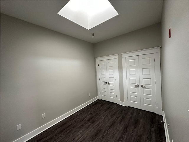 1824 Oretha Castle Haley Blvd Unit 209, New Orleans, LA 70113 - unfurnished bedroom featuring multiple closets and dark wood finished floors