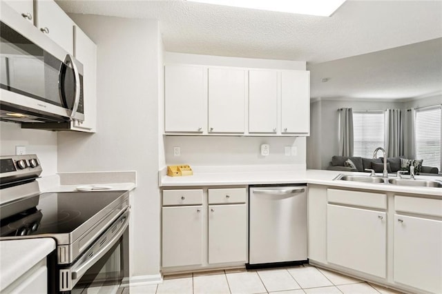 350 Emerald Forest Blvd Unit 6101, Covington, LA 70433 - kitchen with stainless steel appliances, light countertops, white cabinetry, and a textured ceiling