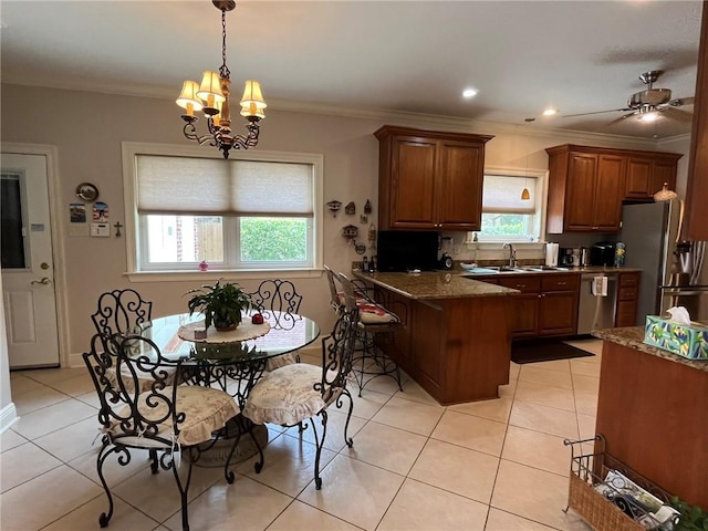 725 Marlene Dr, Gretna, LA 70056 - kitchen with a peninsula, brown cabinetry, crown molding, light tile patterned floors, and a chandelier