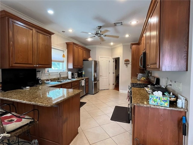 725 Marlene Dr, Gretna, LA 70056 - kitchen featuring stainless steel appliances, a peninsula, a ceiling fan, dark stone countertops, and ornamental molding