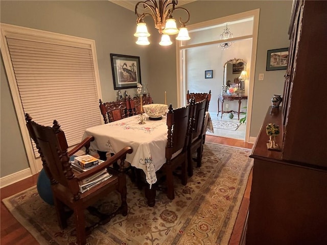 725 Marlene Dr, Gretna, LA 70056 - dining room featuring a chandelier, dark wood-type flooring, and ornamental molding