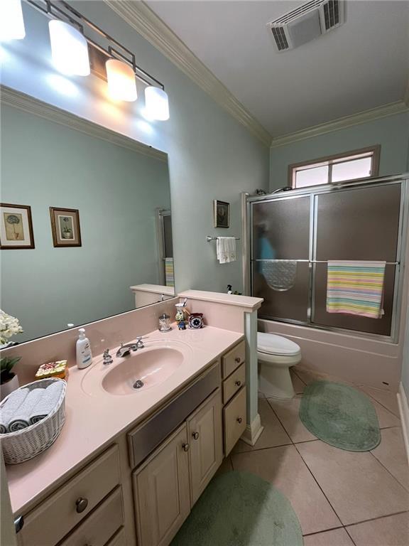 725 Marlene Dr, Gretna, LA 70056 - bathroom with vanity, tile patterned floors, ornamental molding, and bath / shower combo with glass door