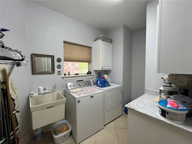 725 Marlene Dr, Gretna, LA 70056 - laundry room featuring washer and clothes dryer, cabinet space, and light tile patterned floors