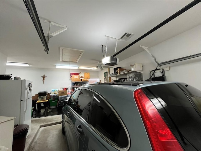 725 Marlene Dr, Gretna, LA 70056 - garage featuring freestanding refrigerator and a garage door opener