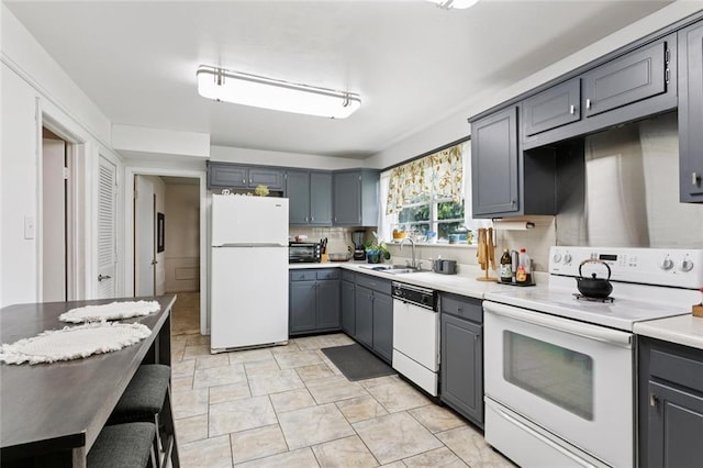 872 Bellemeade Blvd, Gretna, LA 70056 - kitchen featuring white appliances, gray cabinetry, light countertops, and backsplash