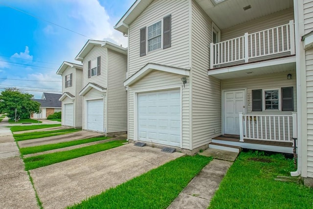 3320 Taft Park Unit C, Metairie, LA 70002 - view of front facade with a balcony, a garage, and driveway