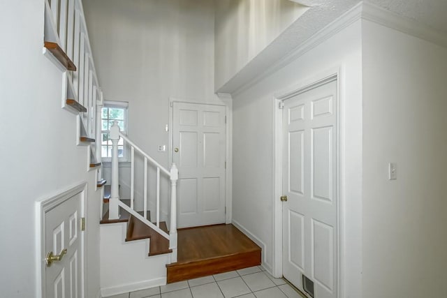 3320 Taft Park Unit C, Metairie, LA 70002 - foyer entrance featuring light tile patterned floors, stairs, and a towering ceiling