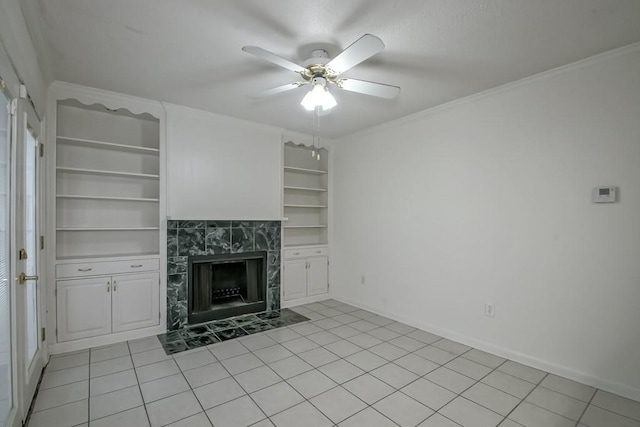 3320 Taft Park Unit C, Metairie, LA 70002 - unfurnished living room with ceiling fan, built in shelves, a high end fireplace, light tile patterned floors, and crown molding