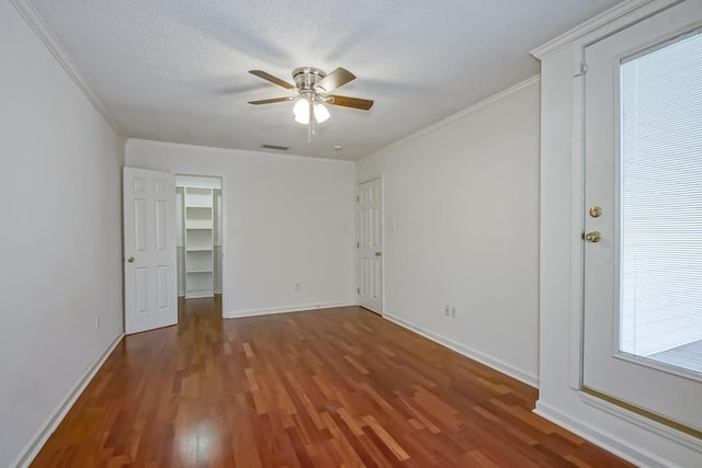 3320 Taft Park Unit C, Metairie, LA 70002 - unfurnished bedroom with ornamental molding, wood finished floors, a spacious closet, and a ceiling fan