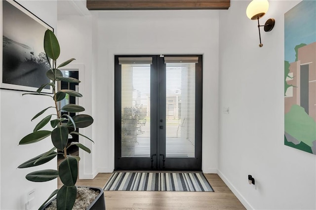 2113 Harmony St, New Orleans, LA 70115 - foyer entrance featuring french doors and wood finished floors