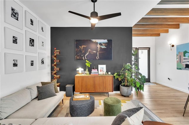 2113 Harmony St, New Orleans, LA 70115 - living area with wood finished floors, an accent wall, and ceiling fan