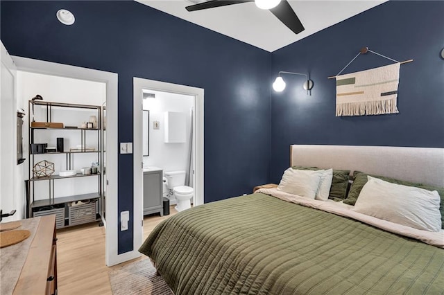 2113 Harmony St, New Orleans, LA 70115 - bedroom featuring wood finished floors and connected bathroom