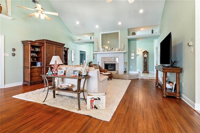3913 Lake Providence Dr, Harvey, LA 70058 - living area featuring a ceiling fan, high vaulted ceiling, a tiled fireplace, and dark wood-style floors