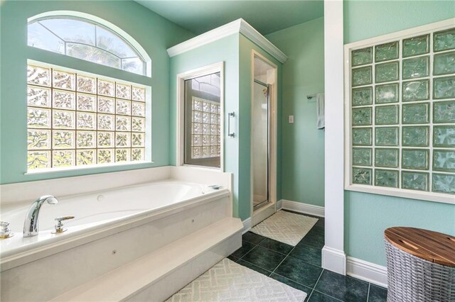 3913 Lake Providence Dr, Harvey, LA 70058 - bathroom with a bath, a stall shower, and tile patterned floors