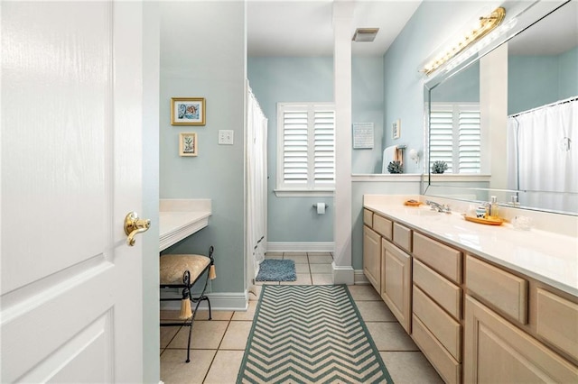 3913 Lake Providence Dr, Harvey, LA 70058 - full bath featuring vanity, tile patterned floors, plenty of natural light, and curtained shower
