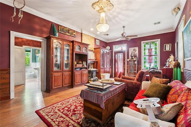 834 Madison St, Gretna, LA 70053 - living area featuring light wood-type flooring, a ceiling fan, and crown molding