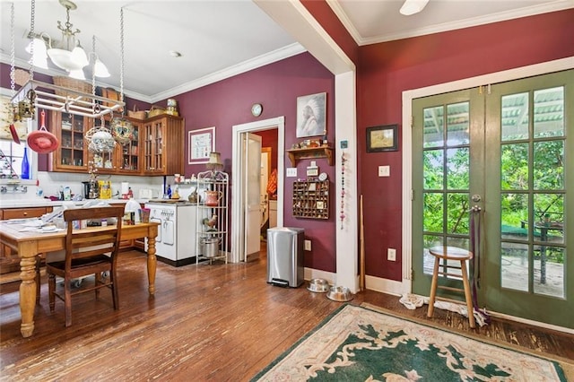 834 Madison St, Gretna, LA 70053 - kitchen featuring dark wood-type flooring, crown molding, light countertops, glass insert cabinets, and a chandelier