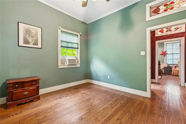 834 Madison St, Gretna, LA 70053 - empty room featuring healthy amount of natural light, wood finished floors, crown molding, and ceiling fan