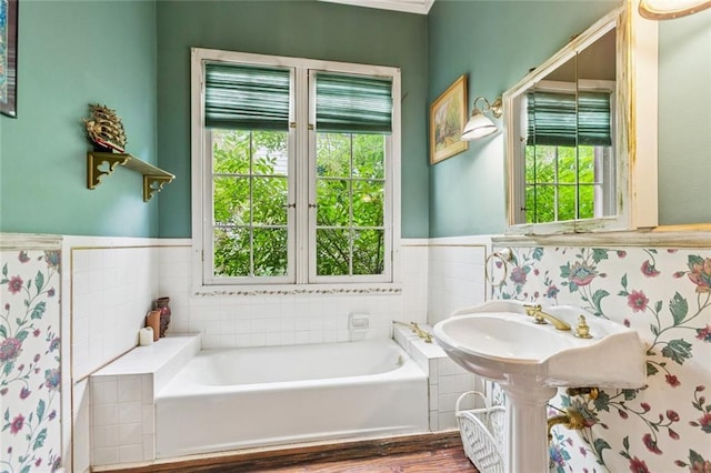 834 Madison St, Gretna, LA 70053 - full bath with a bath, plenty of natural light, a wainscoted wall, wood finished floors, and tile walls