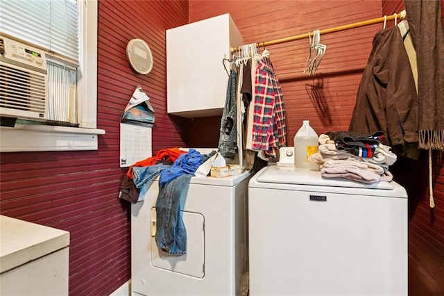 834 Madison St, Gretna, LA 70053 - laundry area featuring separate washer and dryer, wooden walls, and cabinet space