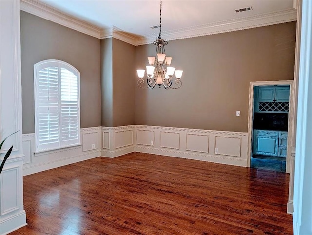 11 Mark Smith Dr, Mandeville, LA 70471 - empty room with ornamental molding, dark wood-type flooring, a chandelier, a wainscoted wall, and a decorative wall