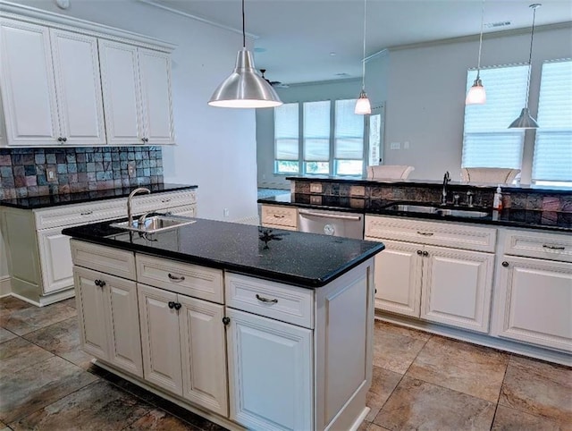 11 Mark Smith Dr, Mandeville, LA 70471 - kitchen with tasteful backsplash, white cabinets, hanging light fixtures, stainless steel dishwasher, and a kitchen island with sink
