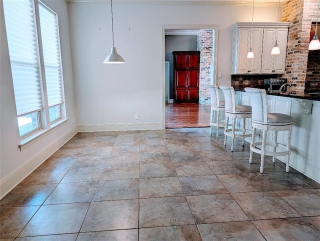 11 Mark Smith Dr, Mandeville, LA 70471 - kitchen featuring dark countertops, decorative light fixtures, decorative backsplash, and crown molding