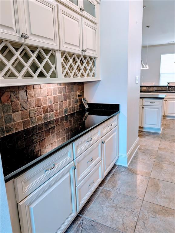 11 Mark Smith Dr, Mandeville, LA 70471 - kitchen featuring tasteful backsplash, white cabinetry, and glass insert cabinets