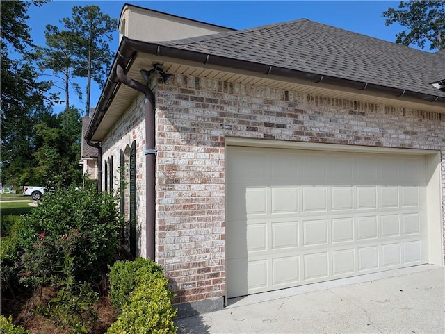 11 Mark Smith Dr, Mandeville, LA 70471 - view of side of home featuring brick siding, a shingled roof, and a garage