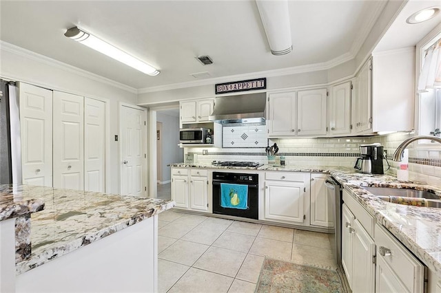 1109 Andrews Ave, Metairie, LA 70005 - kitchen with appliances with stainless steel finishes, decorative backsplash, white cabinets, ventilation hood, and ornamental molding