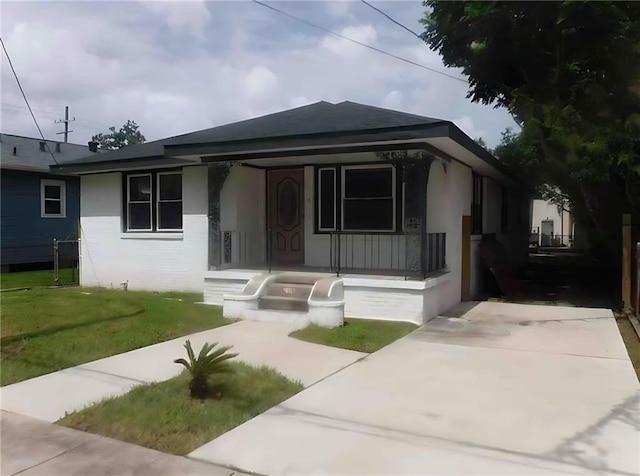 1310 Mazant St, New Orleans, LA 70117 - view of front of property with a porch and a front yard
