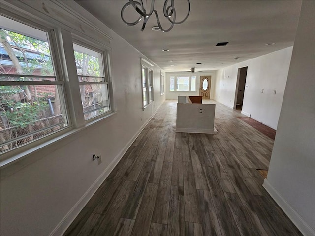 1310 Mazant St, New Orleans, LA 70117 - corridor with dark wood-type flooring, a chandelier, plenty of natural light, and recessed lighting