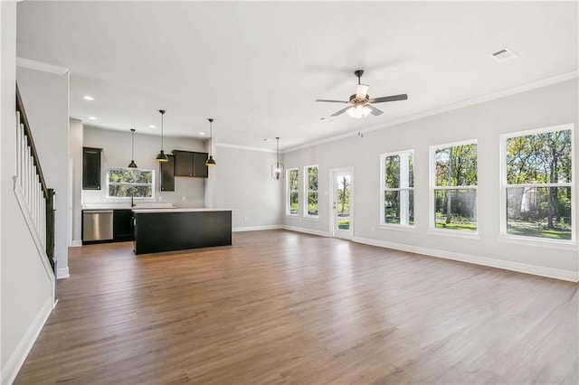 901 Dandelion Dr, Waggaman, LA 70094 - unfurnished living room featuring wood finished floors, recessed lighting, a ceiling fan, stairway, and crown molding