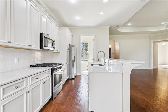 1217 N Starrett Rd, Metairie, LA 70003 - kitchen featuring stainless steel appliances, arched walkways, tasteful backsplash, dark wood-style floors, and crown molding