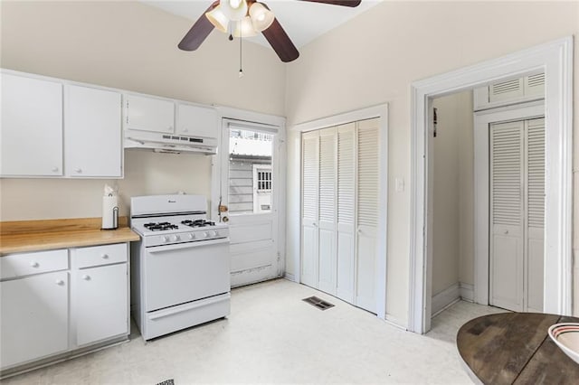 1203 Constantinople St Unit 1, New Orleans, LA 70115 - kitchen with gas range gas stove, ceiling fan, light countertops, white cabinets, and under cabinet range hood