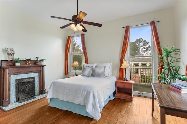 1203 Constantinople St Unit 1, New Orleans, LA 70115 - bedroom with hardwood / wood-style flooring, a fireplace, and a ceiling fan
