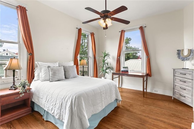 1203 Constantinople St Unit 1, New Orleans, LA 70115 - bedroom featuring multiple windows, wood finished floors, and ceiling fan